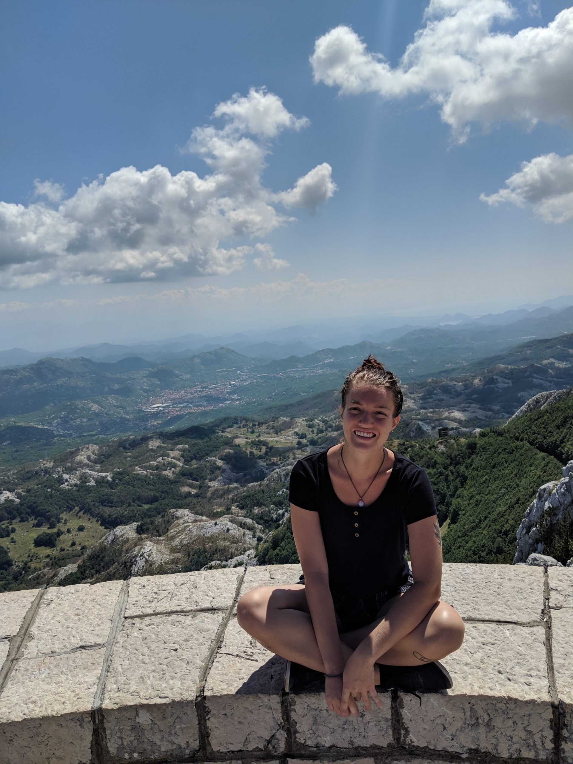 Justyn at a viewpoint in Montenegro overlooking the mountains.