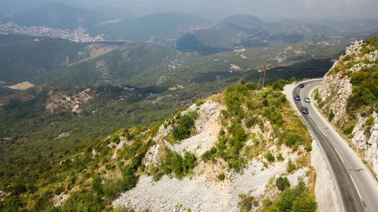 A photo taken from a viewpoint overlooking mountain roads in Montenegro.