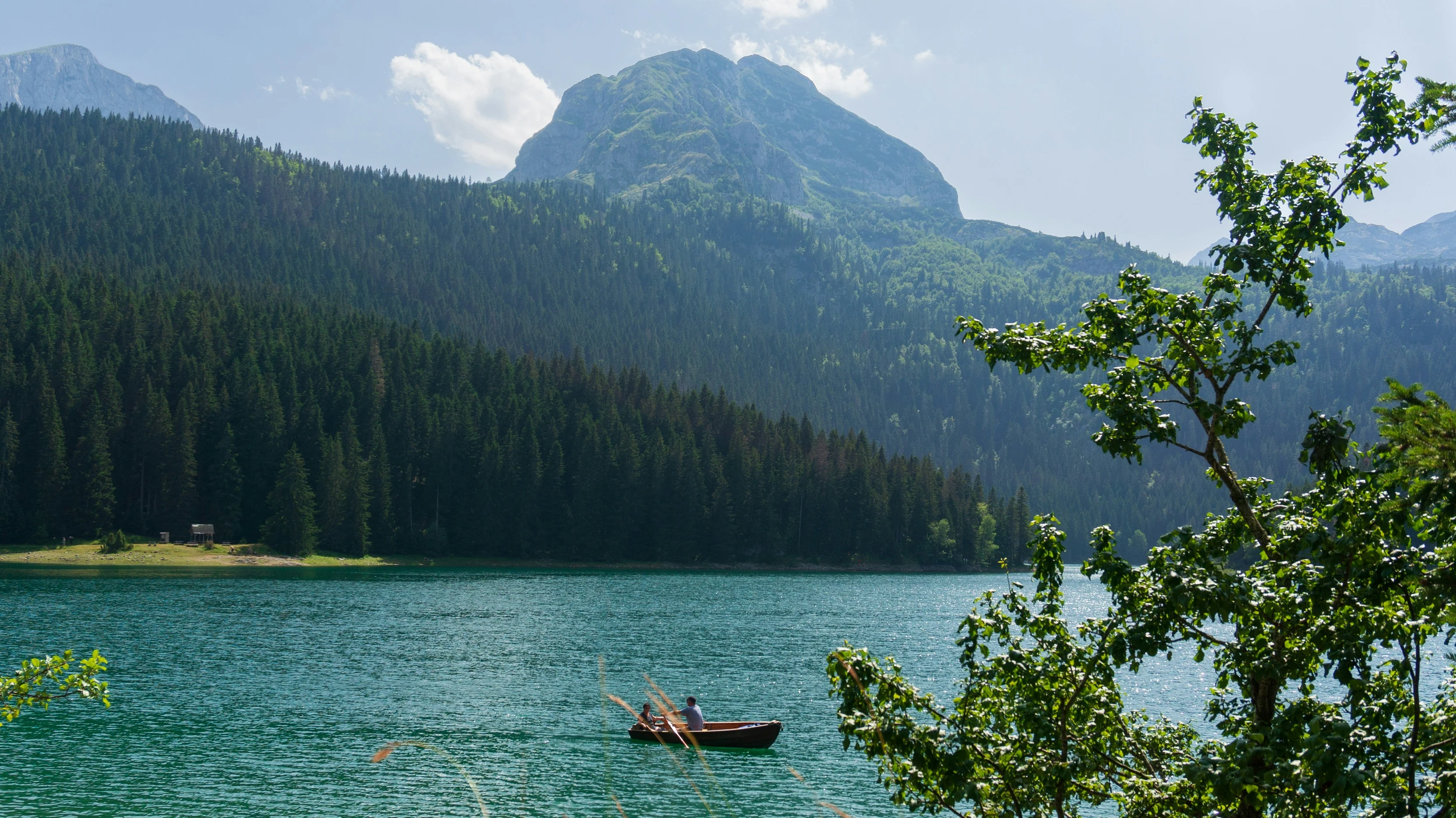 A couple rowing a boat on Zabljak Lake in Montenegro