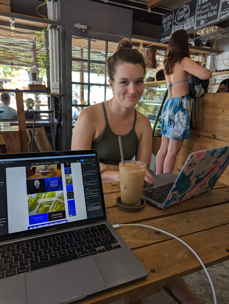 A snap of a macbook with work open and me smiling across the table with my macbook and an iced coffee