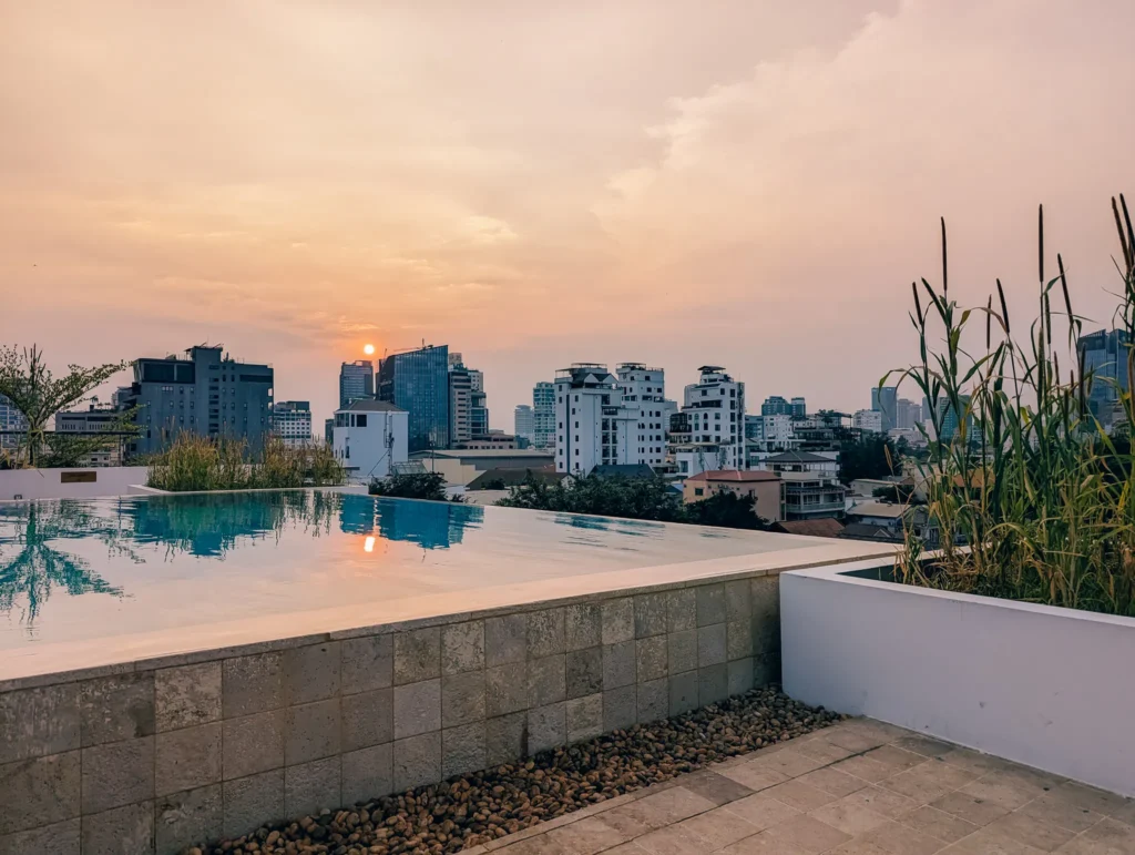 Sunset over the pool at Phnom Penh and Penh House Hotel.