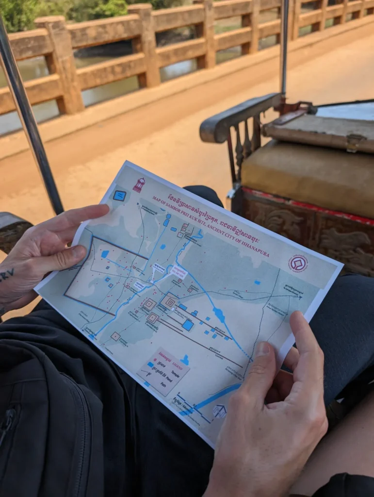 Holding the map of Sambor Prei Kuk.