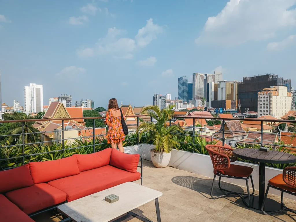 Justyn overlooking Phnom Penh on the rooftop at Pehn House Hotel.