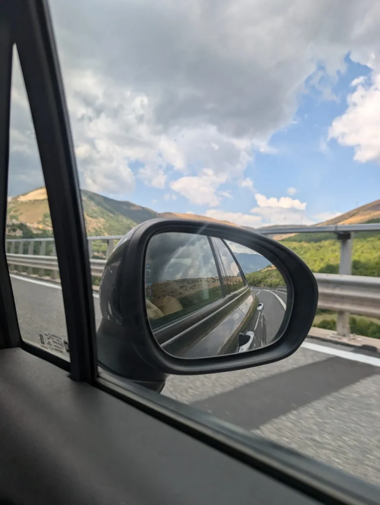 The rearview mirror of our rental car in Italy.