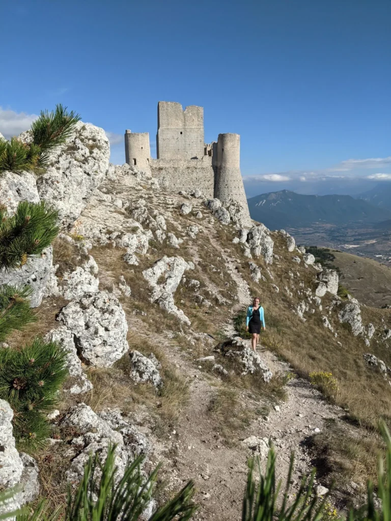 Justyn standing in front of a stone castle in Italy