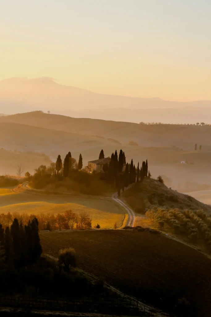 Sunset over a villa in the hills of Tuscany.