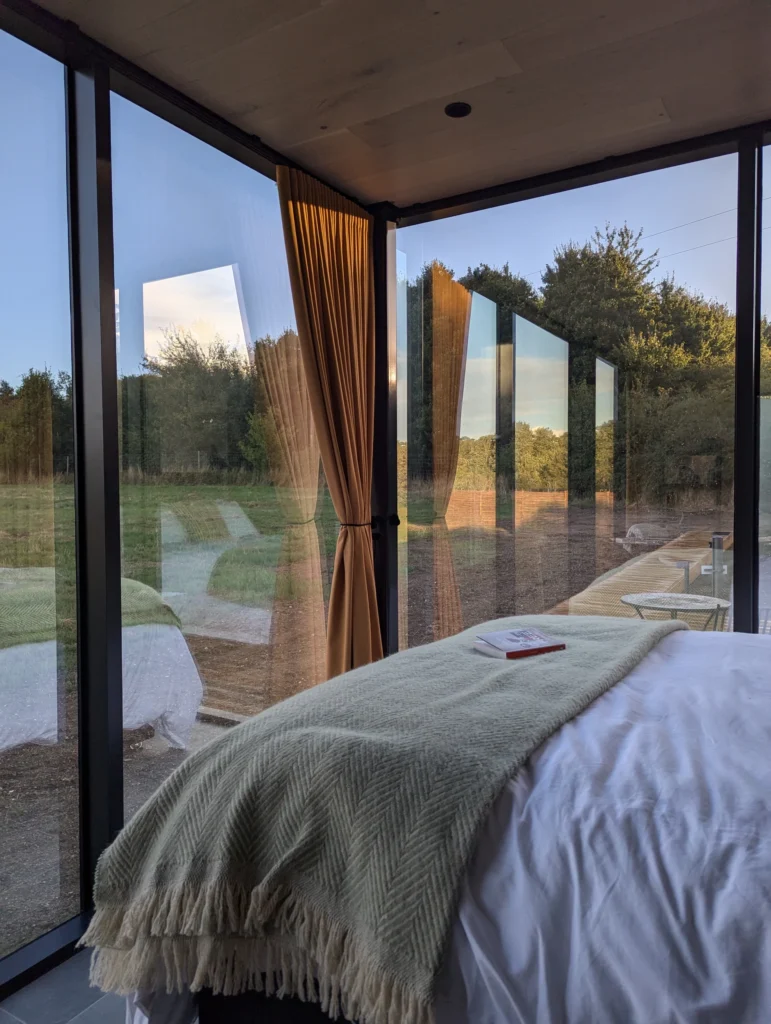 A view of the bed in OOD House with a book sitting on the bed.